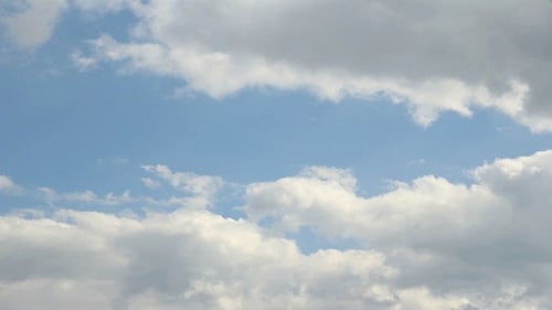 White Clouds Moving Across a Blue Sky
