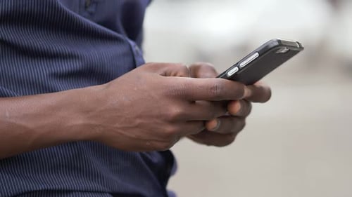 Man Using Smartphone in Urban Setting, Close Up