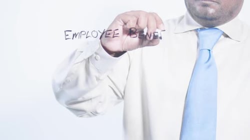 Writing Employee Benefits on Clear Surface
