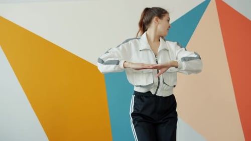 Slow Motion of Beautiful Young Woman Dancing in Dance Studio Wearing Sports Clothing