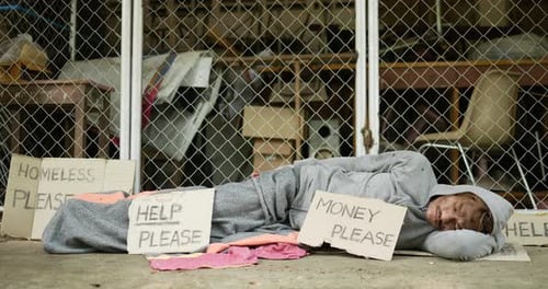 Homeless young man sleeping on the street