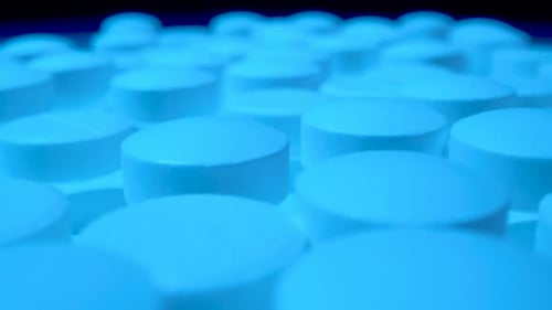 Macro Shot of White Pills with Blue Hue
