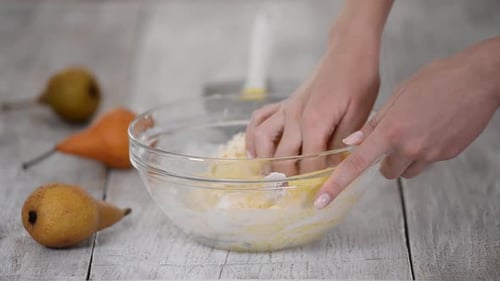 Woman Kneading Dough in Kitchen