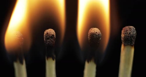 Matches Ignite and Burn Against Black Background