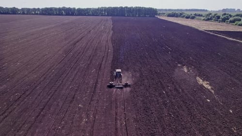 Aerial View of the Tractor Plow a Ground