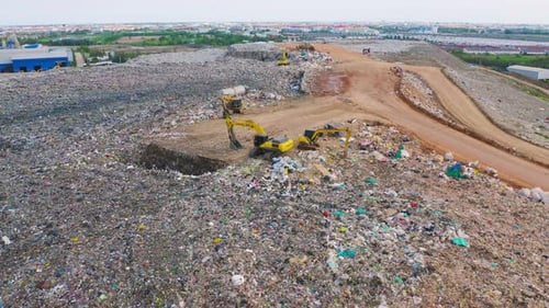 Aerial view of stack of different types of large mountain garbage pile, plastic bags, and trash