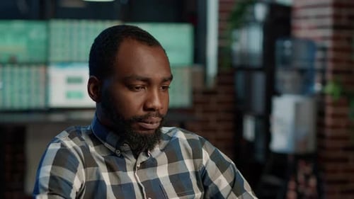 Male Investor Doing Money Banking Work with Stock Market Numbers