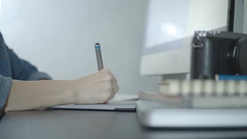 Artist Sketching on Graphics Tablet at Desk