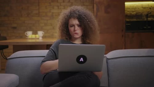 Worried Woman Works on Laptop at Home