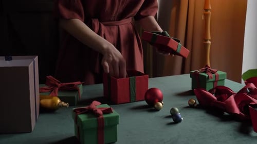 Woman Wrapping Christmas Presents in Cozy Home