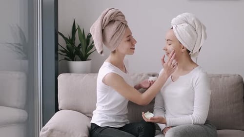 Women Applying Beauty Cream Together Indoors