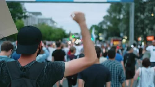 Crowd of People Marching in Urban Protest