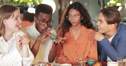 Crop View of African American Young Man in Glasses Gesturing While Telling Funny Story Friends in