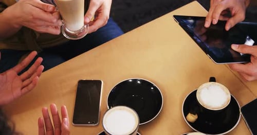 Friends Gather at Cafe with Devices