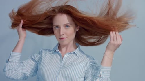 Woman with Red Hair Tossing Hair