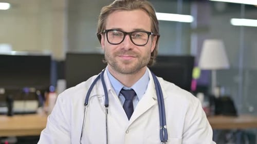 Friendly Doctor Smiling in Medical Office