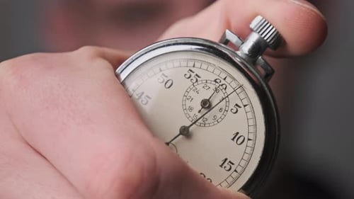 Stopwatch in Male Hand Counts Down Seconds