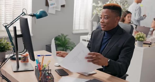 Boss Working in an Office Man is Sitting Behind Desk in Front of Computer Checking Correctness of