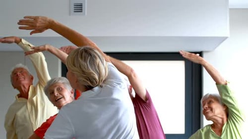 Smiling Seniors Exercising Together in Fitness Class