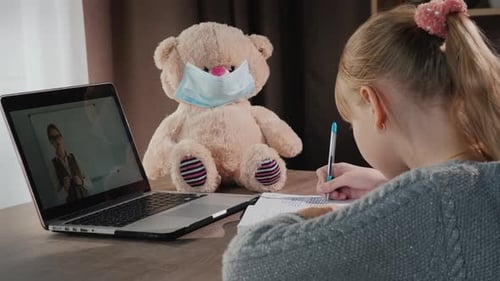 Child Studying Online With Teddy Bear