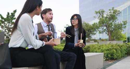 Diverse business people doing lunch break outdoor from office building