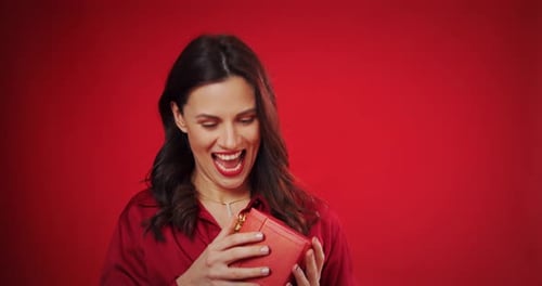 Excited Woman Opening a Red Gift Box
