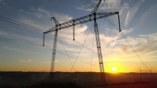 High Voltage Tower with Electric Power Lines at Sunset