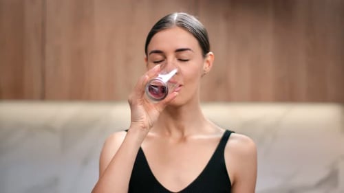 Portrait of Woman Smiling Drinking Pure Water From Glass