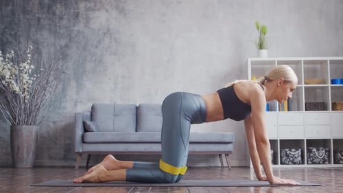 Woman Doing Leg Lift Exercise With Resistance Band