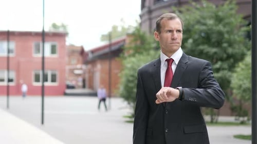 Man in Suit Checking His Watch
