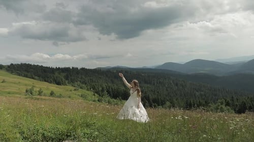Woman in White Dress in Mountain Meadow