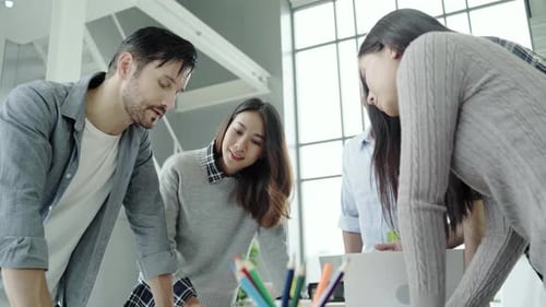 Group of casually dressed business people discussing ideas in the office