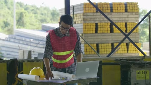 Construction Worker Working With Computer At Construction Site