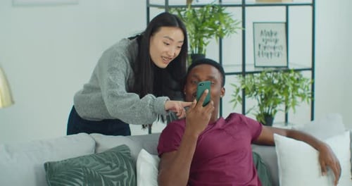 Man Show Explain to Beloved Girl New App Resting at Home Spend Time Together Use Wireless Tech