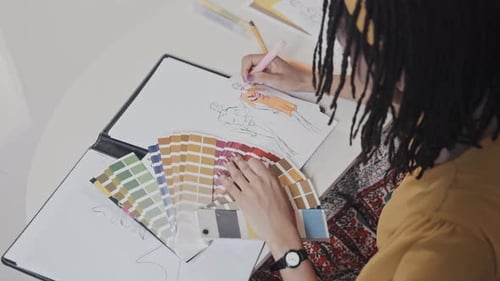 Fashion Designer Sketching Designs at Home