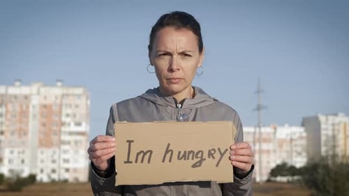Worried Woman Holding 'I'm Hungry' Sign
