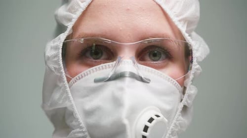 Person Wearing Protective Medical Suit and Face Mask