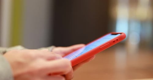 Hands Scrolling on Mobile Phone Close Up