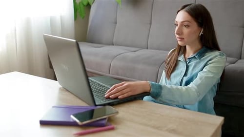 Woman Working From Home on Laptop Computer