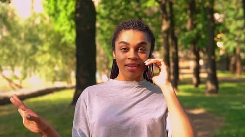 Portrait Female Has Phone Conversation on the Run