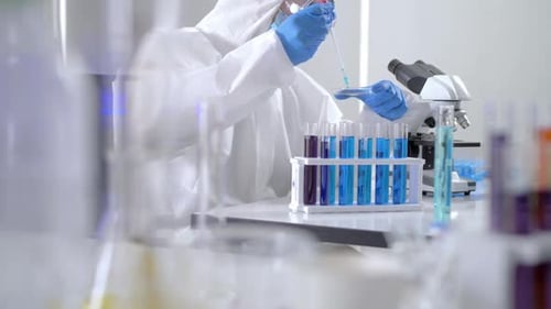 Scientist Experimenting with Test Tubes in Lab