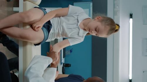 Doctor Examines Child's Arm in Medical Office