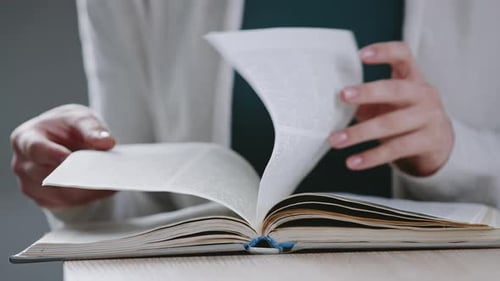 Close Up Female Hands of Young Unrecognizable Caucasian Woman Student Girl Turns Pages in Dictionary