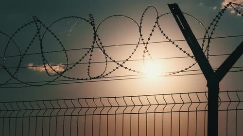 Barbed Wire Fence at Sunset