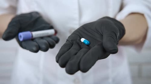 Doctor Holding Coronavirus Test and Pill Treatment