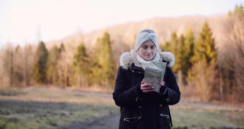 Woman Reading Map on Outdoor Adventure