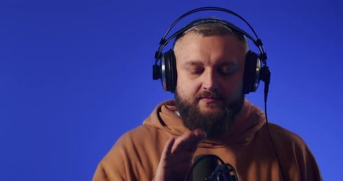 Closeup of a European Podcast Blogger Smiling While Broadcasting His Live Audio Podcast in a Studio