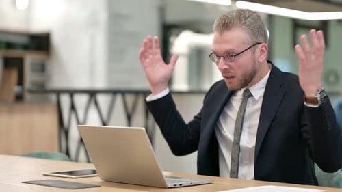 Loss Young Businessman Reacting to Failure on Laptop in Office