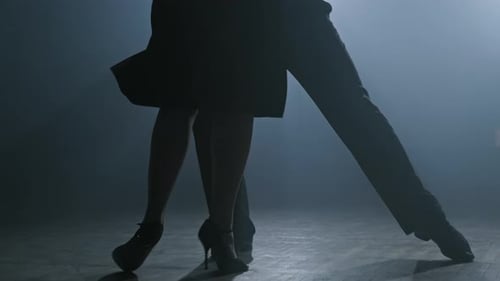 Legs of Couple Dancing Tango in Dark Smoky Studio in Slow Motion in , UHD