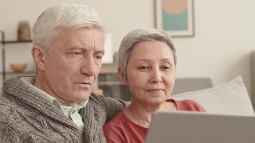 Senior Couple Enjoys Laptop Together at Home